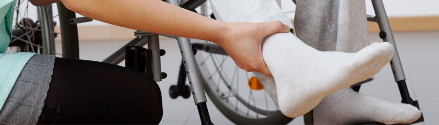 nurse holding patients ankle