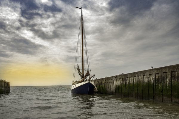A large ship docked, with a grey sky by Laura Prieto