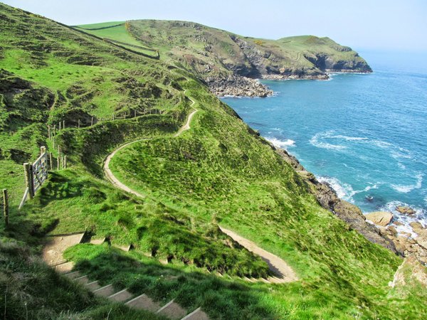 Linda Sadler's entrance to #myhappyplace showing a bending green track on a cliff side