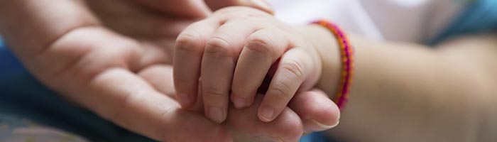 holding newborn hand